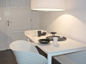 a white table with a plate of food on it at Apartment Residenza Chesa Margun 46-2 by Interhome in Surlej