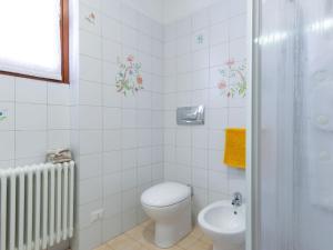 a bathroom with a toilet and a sink at Apartment Stefania - VNA370 by Interhome in Varenna
