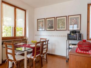 a kitchen and dining room with a table and chairs at Apartment Stefania - VNA370 by Interhome in Varenna