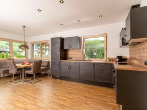 a kitchen and dining room with a table and chairs at Apartment Apart Jasmin by Interhome in Ramsau im Zillertal