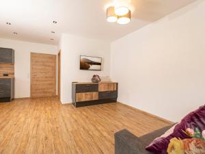 a living room with white walls and wooden floors at Apartment Apart Jasmin by Interhome in Ramsau im Zillertal +26 photos