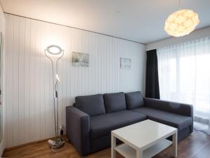 a living room with a blue couch and a table at Studio Greppon 107 by Interhome in Les Collons