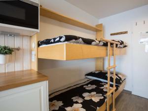 a small bedroom with bunk beds in a tiny house at Studio Greppon 107 by Interhome in Les Collons
