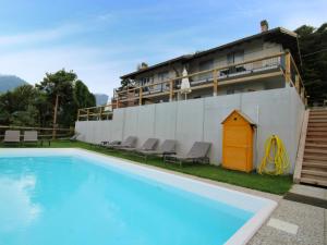 a swimming pool in front of a building at Apartment Europa-1 by Interhome in Ledro