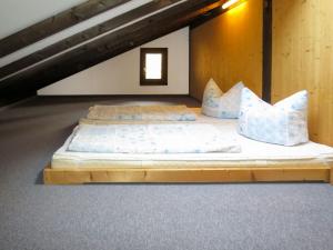 two beds in a room with a loft at Apartment Fliederweg by Interhome in Siegsdorf