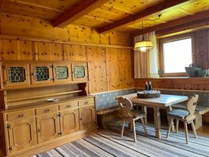 a kitchen with a table and chairs in a cabin at Apartment Häuser by Interhome in Ried im Zillertal