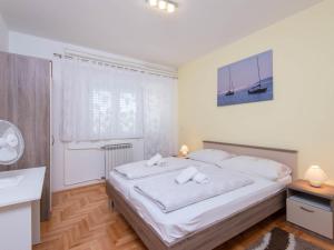 a bedroom with a bed with two towels on it at Apartment Balota by Interhome in Viganj