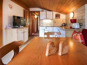 a kitchen with a table with two wooden hearts on it at Apartment Elisabeth - APH311 by Interhome in Alpbach