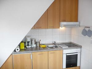 a small kitchen with a sink and a stove at Apartment Biohof Herrenweg-2 by Interhome in Dreimühlen