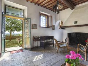 a living room with a fireplace and a table at Holiday Home Belvedere by Interhome in Filettole