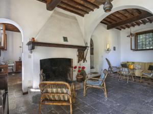 a living room with a fireplace and chairs at Holiday Home Belvedere by Interhome in Filettole