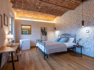 a bedroom with a bed and a table in a room at Holiday Home Tenuta Margherita by Interhome in Portacomaro