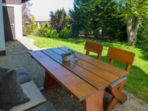 ein Picknicktisch aus Holz und zwei Stühle im Hof in der Unterkunft Holiday Home Drachenfels by Interhome in Dittishausen
