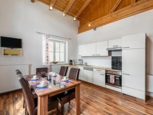 a kitchen with a wooden table and a wooden floor at Apartment Rot by Interhome in Lend +23 photos