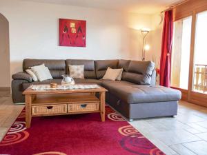 a living room with a couch and a coffee table at Apartment Grand Panorama C5 by Interhome in Nendaz