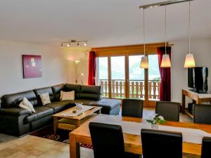 a living room with a couch and a table at Apartment Grand Panorama C5 by Interhome in Nendaz