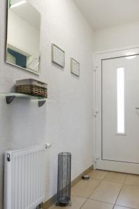 a white room with a mirror and a door at Holiday Home Mily by Interhome in Dittishausen +23 photos