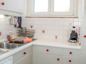 a kitchen with white cabinets and a sink at Apartment Residenza Corallo-16 by Interhome in Ascona