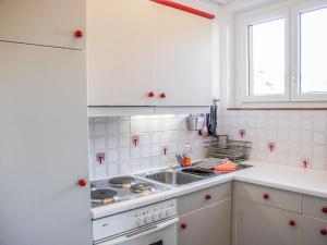 a kitchen with white cabinets and a sink at Apartment Residenza Corallo-16 by Interhome in Ascona