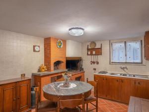 a kitchen with a table with chairs and a sink at Holiday Home Capanna by Interhome in San Clemente in Valle