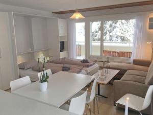 a living room with a couch and a table at Apartment Val Signina-2 by Interhome in Laax-Murschetg
