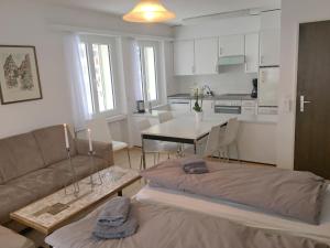 a living room with a couch and a table at Apartment Val Signina-2 by Interhome in Laax-Murschetg +25 photos