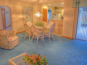 a dining room with a table and chairs and a kitchen at Holiday Home Sunrise by Interhome in Palm Coast