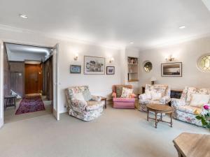 a living room with chairs and a table at Holiday Home Jeanettes by Interhome in New Malden