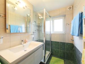 a bathroom with a sink and a shower at Apartment Sonnhalde B by Interhome in Zermatt