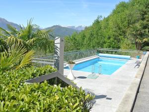 a swimming pool in the middle of a garden at Apartment Aldesago Monte Brè - Utoring-31 by Interhome in Viganello