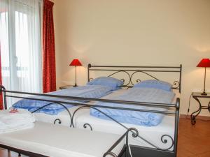 a bedroom with two beds with blue pillows at Apartment Residenza Monte Bré - Apt-004 Haus1 by Interhome in Lugano