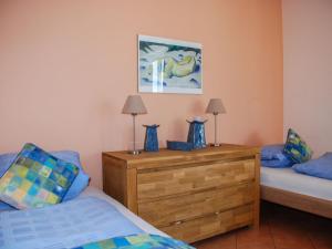 a bedroom with two beds and two lamps on a wooden dresser at Apartment Residenza Monte Bré - Apt-004 Haus1 by Interhome in Lugano