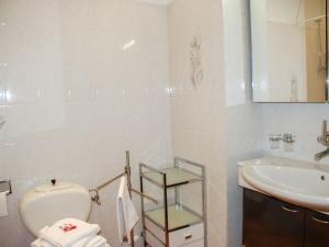 a bathroom with a toilet and a sink at Apartment Residenza Monte Bré - Apt-004 Haus1 by Interhome in Lugano