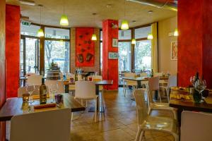 a restaurant with tables and chairs and red walls at Camping Il Boschetto Di Piemma in San Gimignano