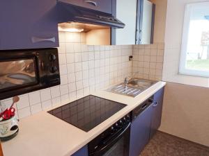 a small kitchen with a sink and a stove at Apartment Schuler by Interhome in Unterkirnach
