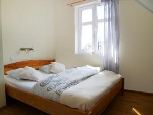 a bed in a room with a window at Holiday Home Domek Joanna-1 by Interhome in Łeba