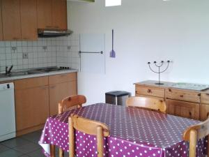 a kitchen with a table with a polka dot table cloth at Holiday Home Au bord du Lac-2 by Interhome in Butgenbach