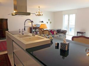 eine Küche mit einem Waschbecken und ein Wohnzimmer in der Unterkunft Apartment Haute-Rive by Interhome in Montreux