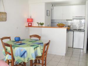 a kitchen with a table and chairs in a room at Apartment Cap Océan by Interhome in Mimizan-Plage