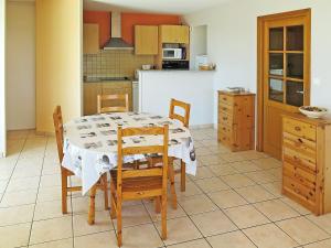 a kitchen with a table and chairs in a kitchen at Apartment Côte Sud-3 by Interhome in Mimizan-Plage