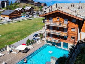 an aerial view of a house with a swimming pool at Apartment Le Refuge 1 by Interhome in Nendaz