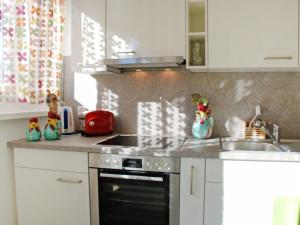 a kitchen with a stove and a sink in it at Apartment App- Paradiso by Interhome in Paradiso +20 photos