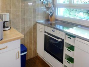a kitchen with a stove and a counter top at Holiday Home Noisette by Interhome in Chardonne