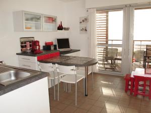 a kitchen with a table with a laptop on it at Studio Horizon-1 by Interhome in Mimizan-Plage