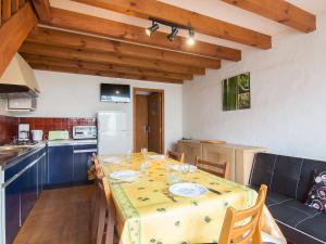 a dining room with a table and a kitchen at Holiday Home Sicard-6 by Interhome in Mimizan-Plage