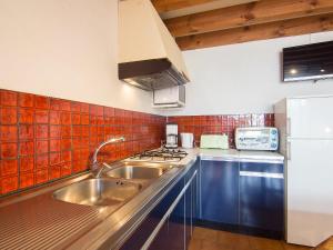 a kitchen with a sink and a stove at Holiday Home Sicard-6 by Interhome in Mimizan-Plage