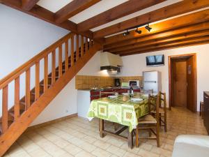 a kitchen and dining room with a table and a staircase at Holiday Home Sicard-5 by Interhome in Mimizan-Plage