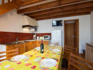 a kitchen with a table with a bottle of wine on it at Holiday Home Sicard-9 by Interhome in Mimizan-Plage
