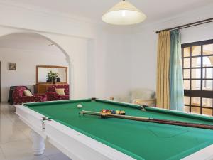 a living room with a pool table in a room at Villa Villa Quinta do Sol by Interhome in Armação de Pêra