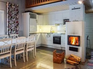 a kitchen with a table and a fire in the oven at Holiday Home Villa unari by Interhome in Unari